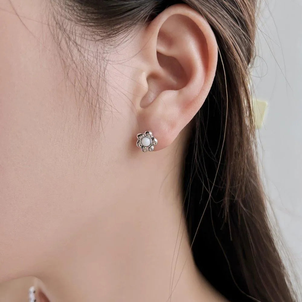 Pair of S925 sterling silver ear studs with black agate flower centre, gold colour, simple geometric shape
