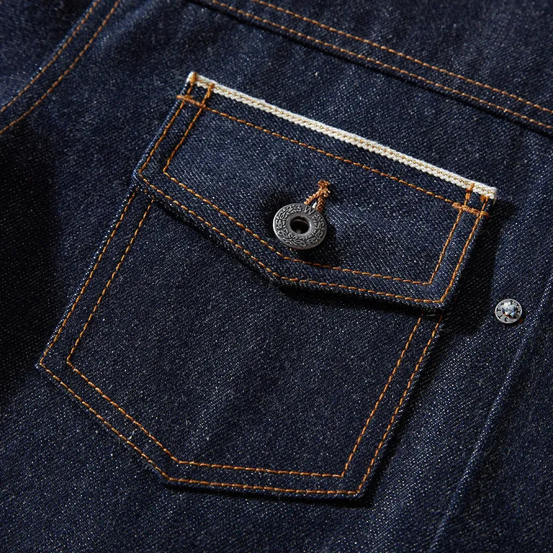 Man wearing a raw pulp coloured loose Japanese-style cotton jacket with red edge trim and patch pockets.