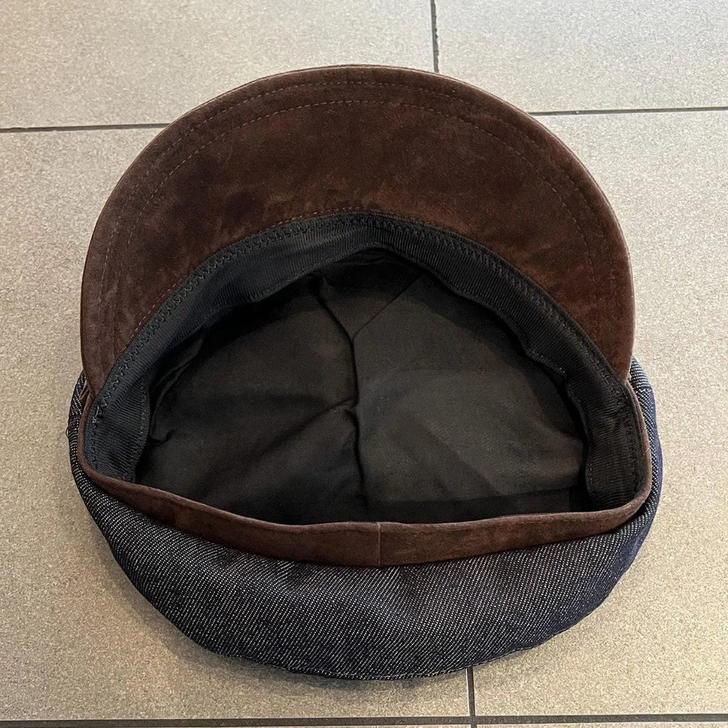 Dark blue denim adjustable octagonal newsboy cap shown on a neutral background.