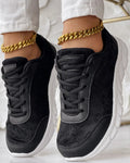 Women's casual canvas sports shoe in four colour options: white, black, blue, and pink, shown with a flat heel.