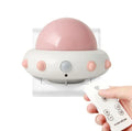 Remote control UFO shaped bedside night light in blue, pink or white colours on a table