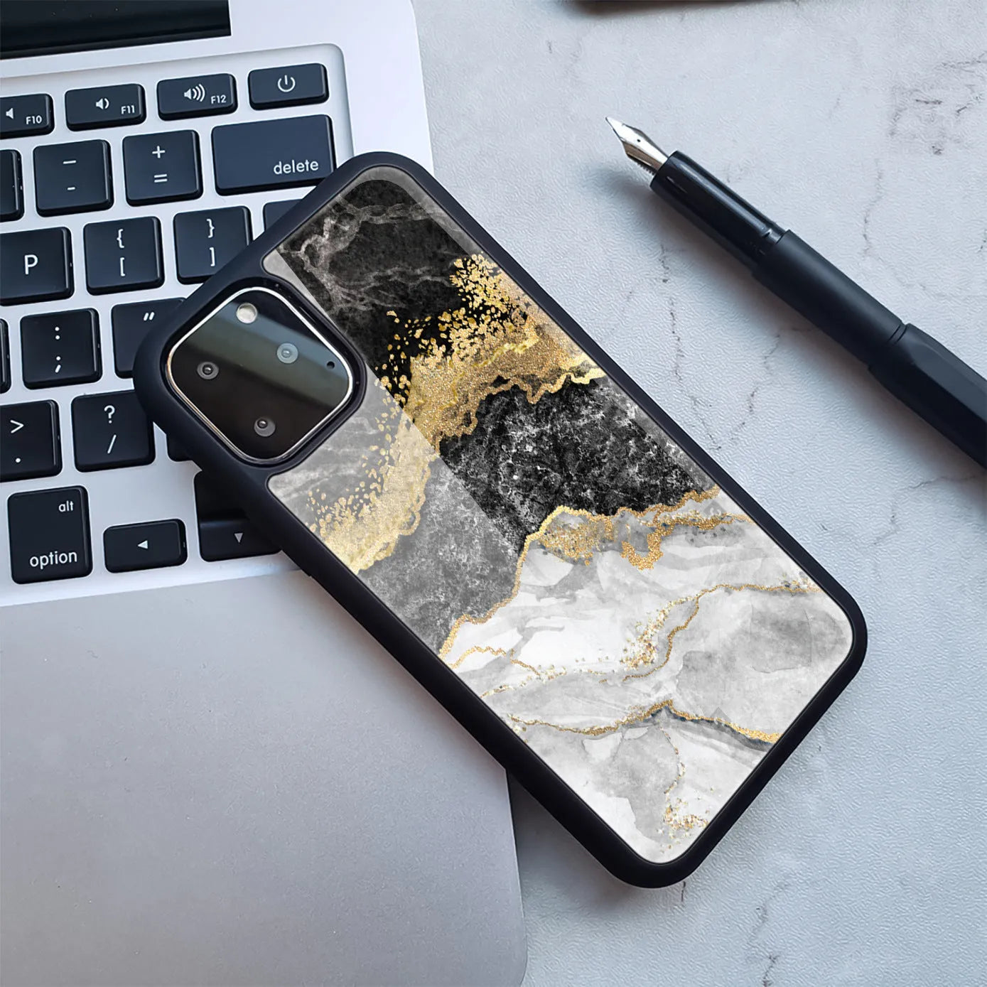 Marbled plastic back cover phone case for iPhone in blue gold and black gold colour options.