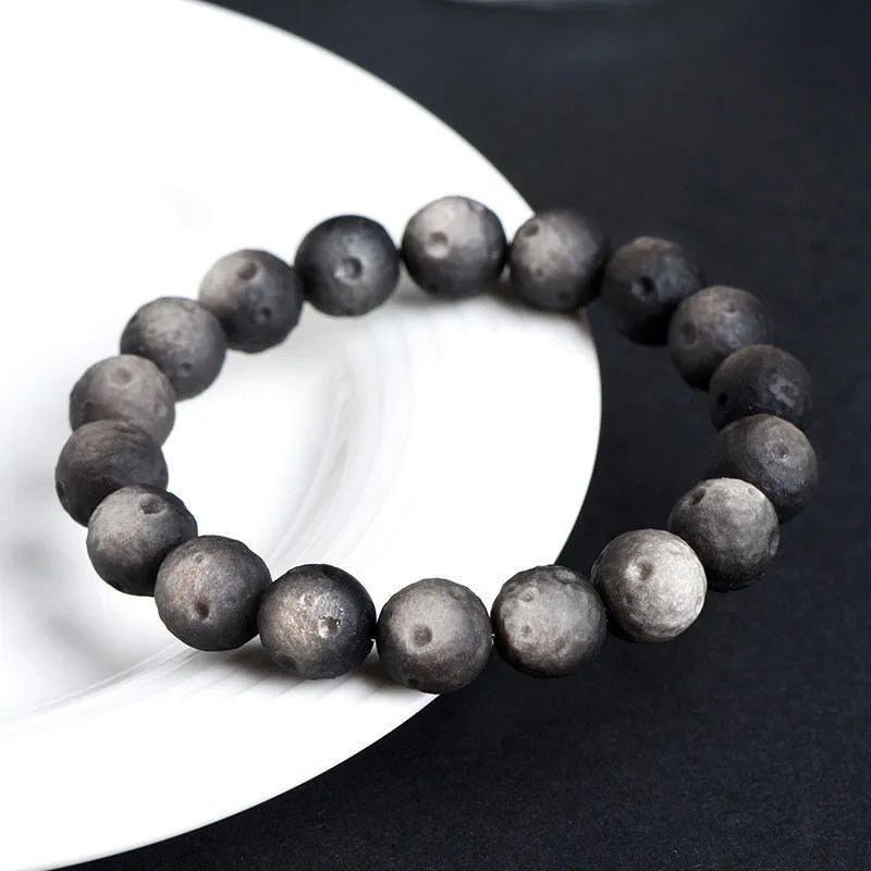Natural obsidian crater ball bracelet with grinding texture in silver or golden meteorite colours