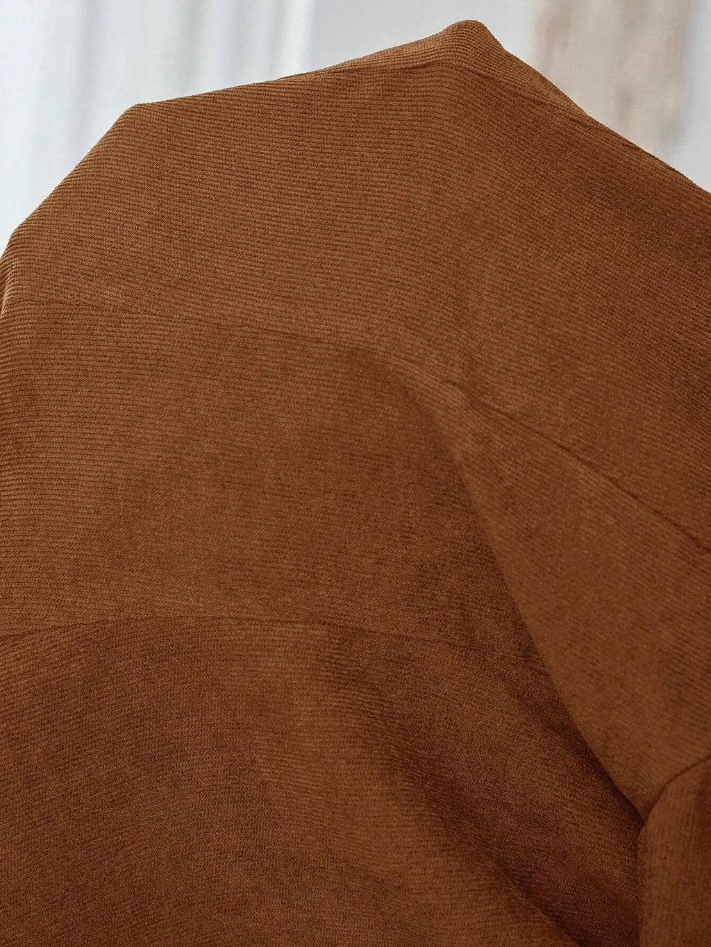 Brown single-breasted lapel coat for men with long sleeves, shown on a hanger.