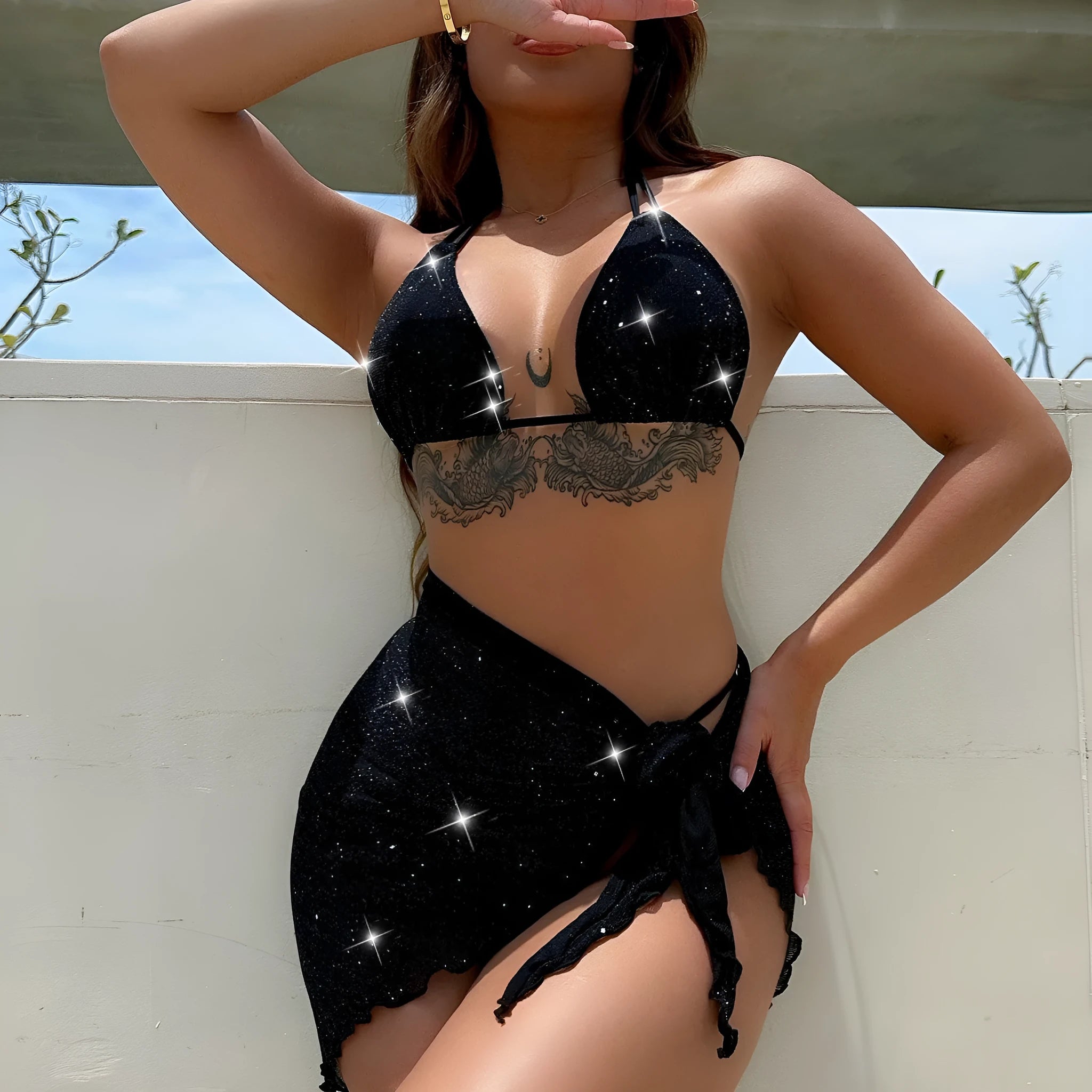 Black three-piece bikini swimsuit set with a top and shorts on a mannequin.