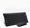 Black and white wireless keyboard and mouse set on a wooden desk.