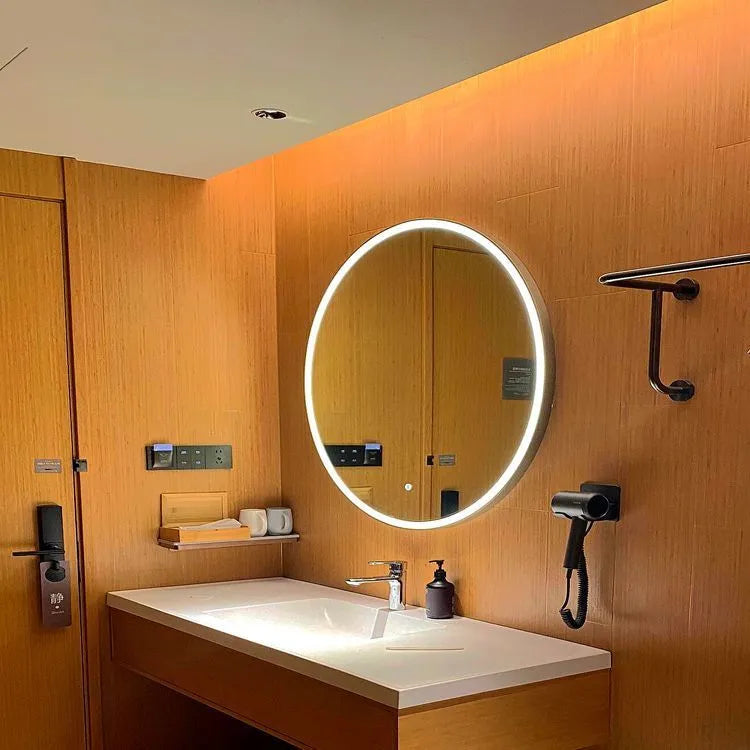 Round black aluminium frame smart bathroom mirror with dimmable LED lights on a wall.