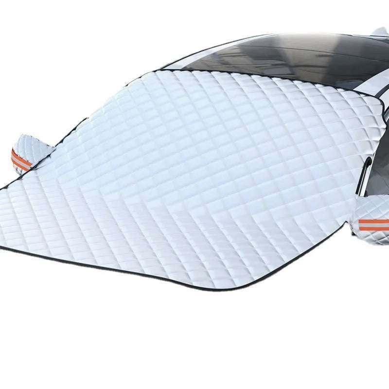 Large aluminium foil winter car cover for SUVs with reflective stripes and magnets on a vehicle windshield.