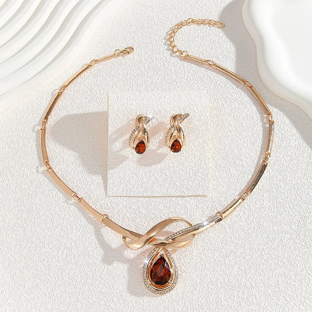 Gold alloy necklace and earrings set with white rhinestone and brown crystal inlay, V-shaped pendant, fishtail fan design