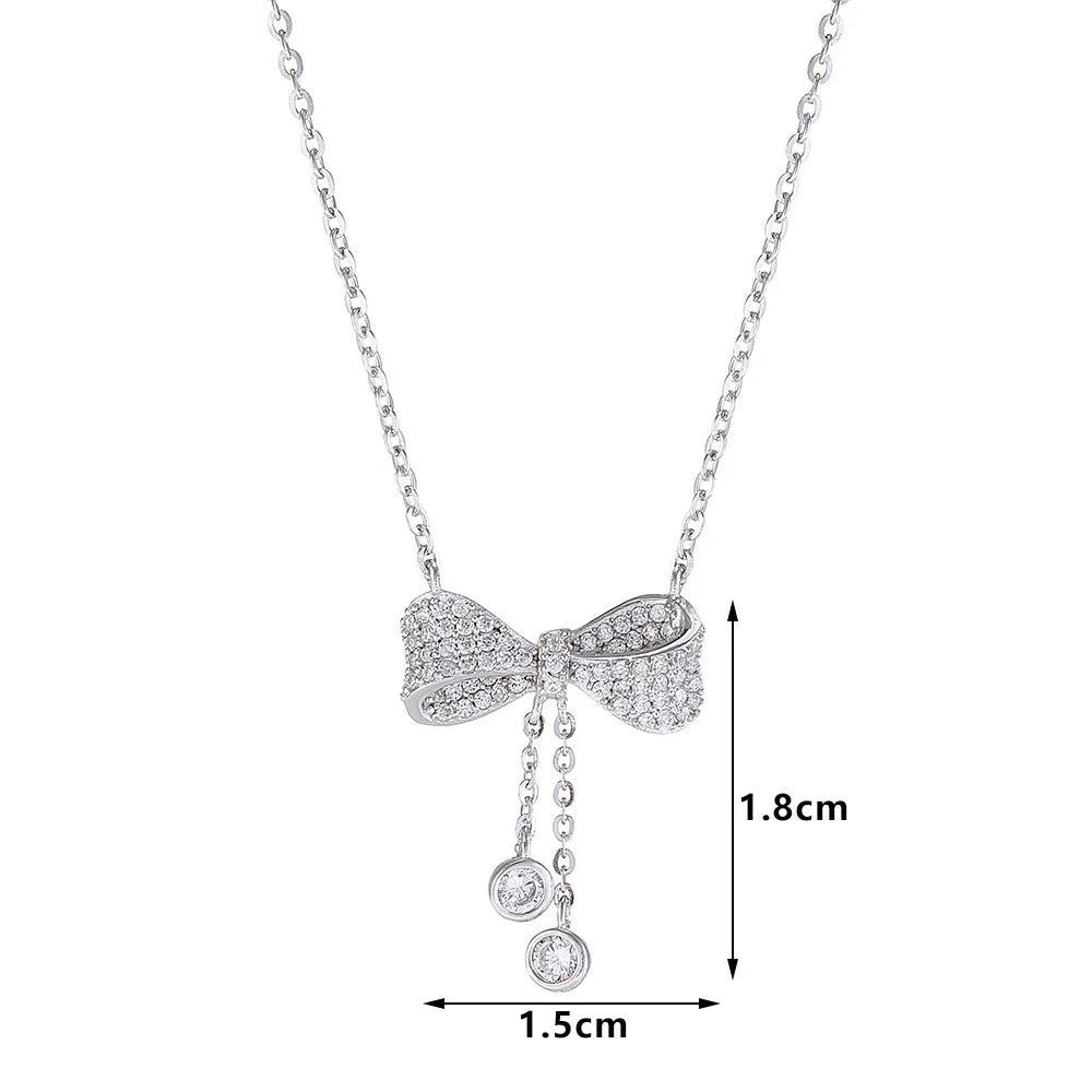 S925 sterling silver necklace with bow pendant on an O-ring chain, shown at clavicle length.