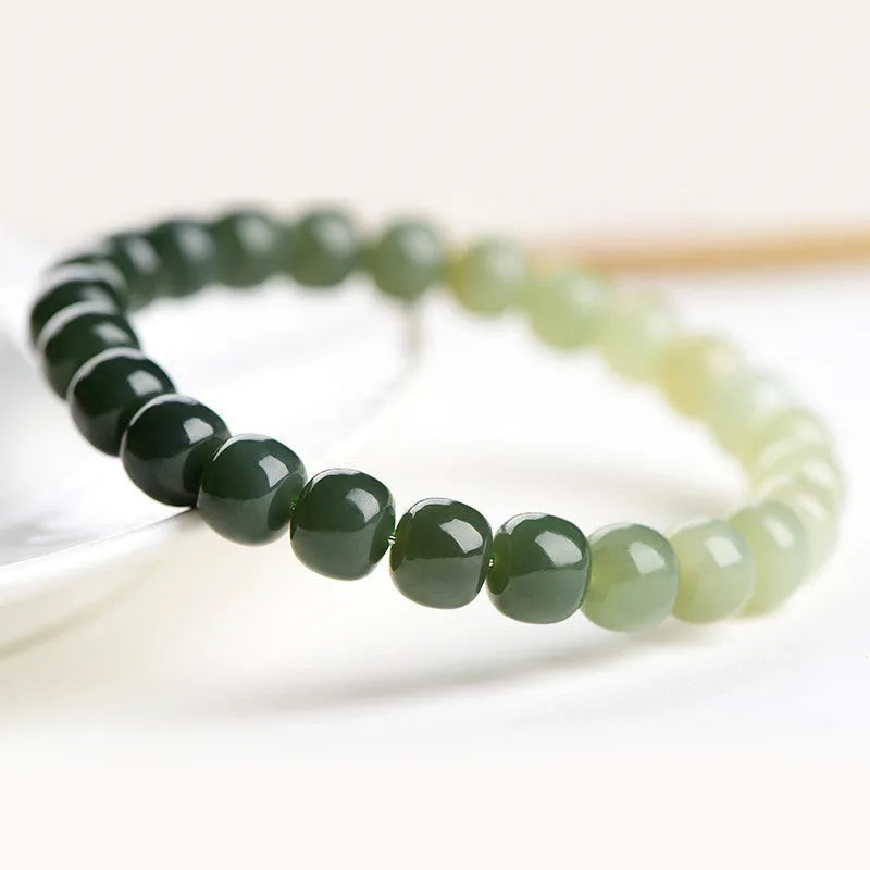 Polished Hetian jade bracelet with gradient clear water colour and round beads.