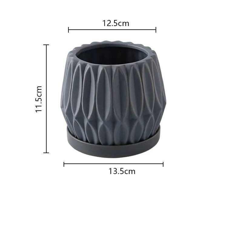A simple grey ceramic flowerpot, medium-sized, for tabletop or floor plants.