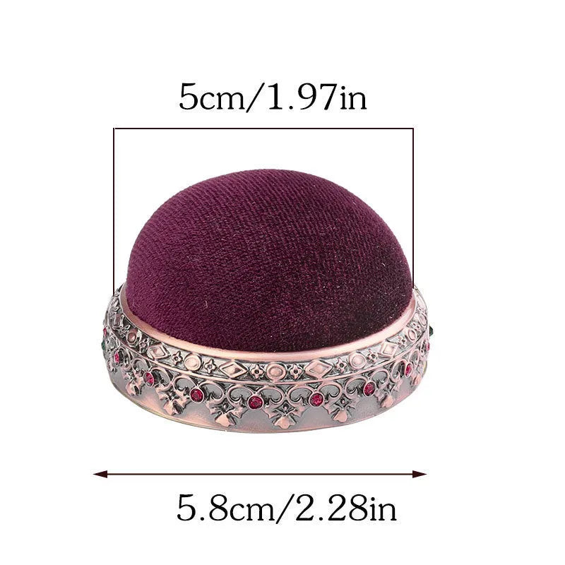 Retro needle ball head pin cushion with velvet cover and alloy insert on sewing table