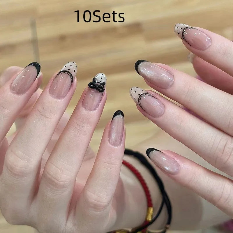 Pack of sweet pastel coloured press-on false nails for girls on a pink background.