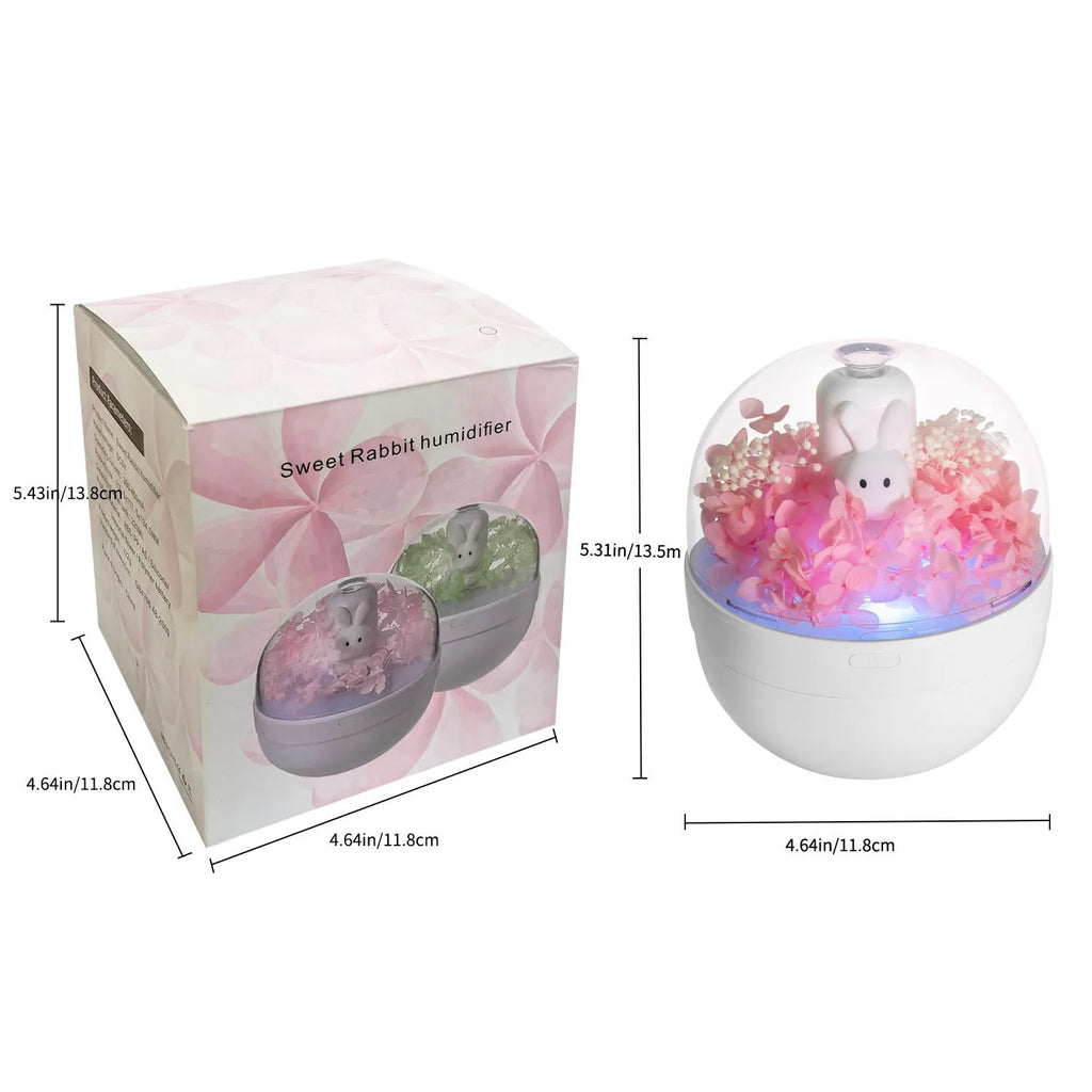 Pink rabbit-shaped aromatherapy humidifier with preserved flower decoration on bedside table
