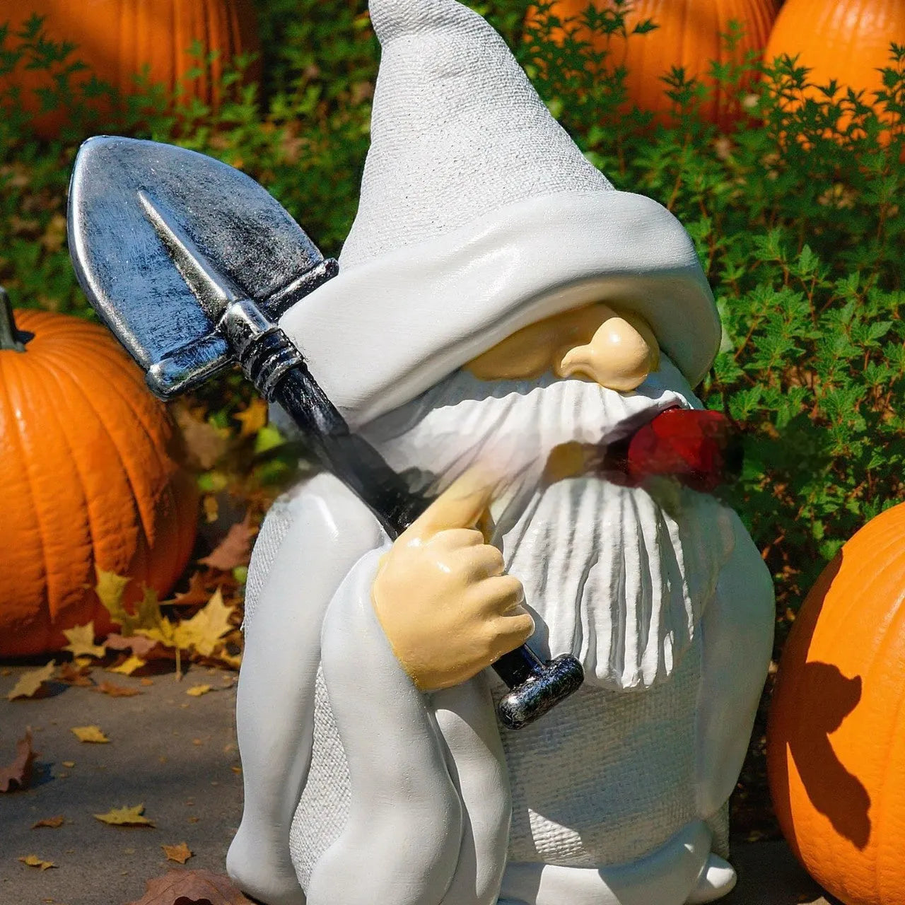 A small resin and plastic Smoking Shovel Dwarf ornament for Christmas garden decoration.