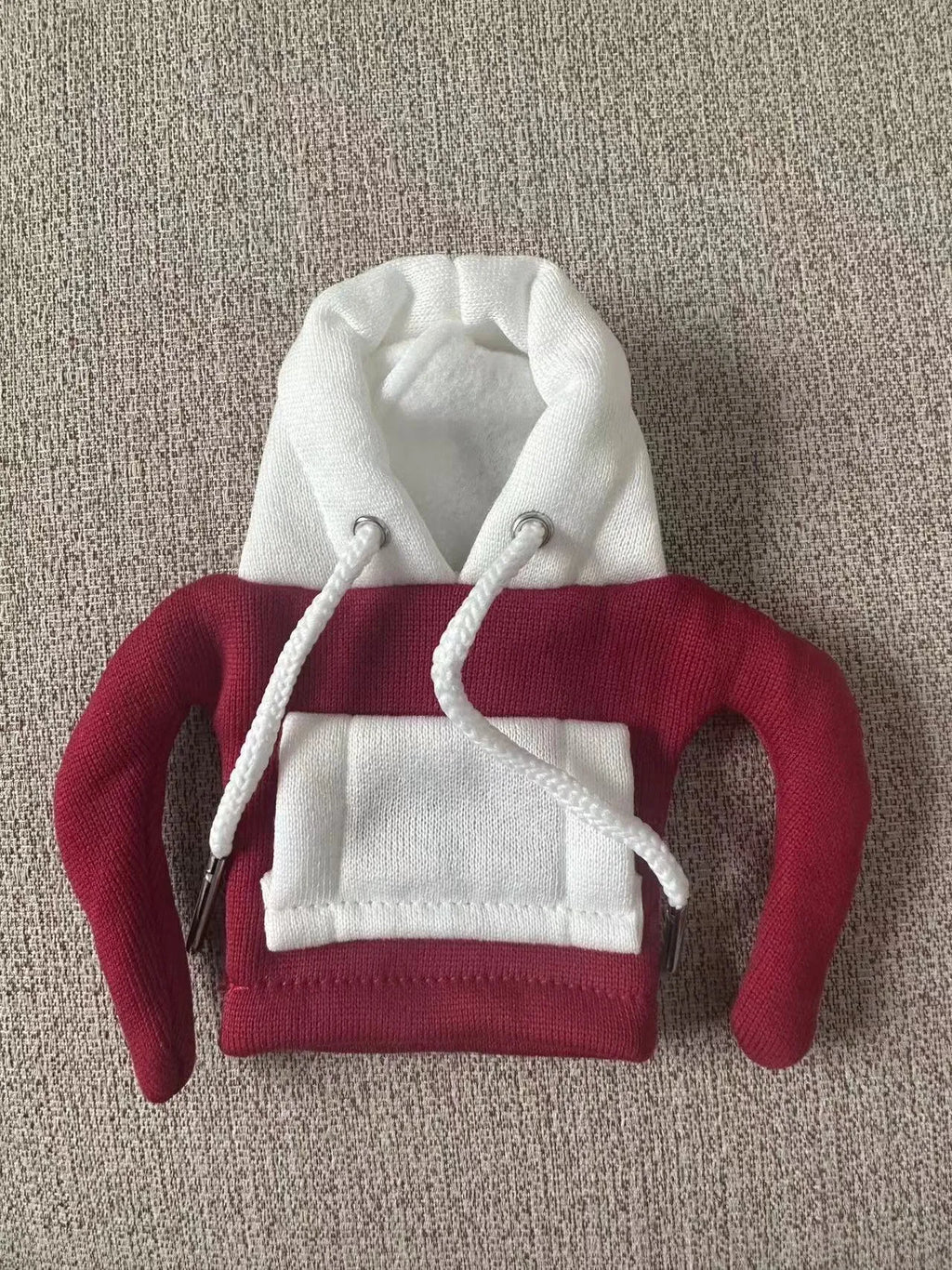 Polyester knit hooded cover stretched over a car manual gear lever in a red and white colour combination.