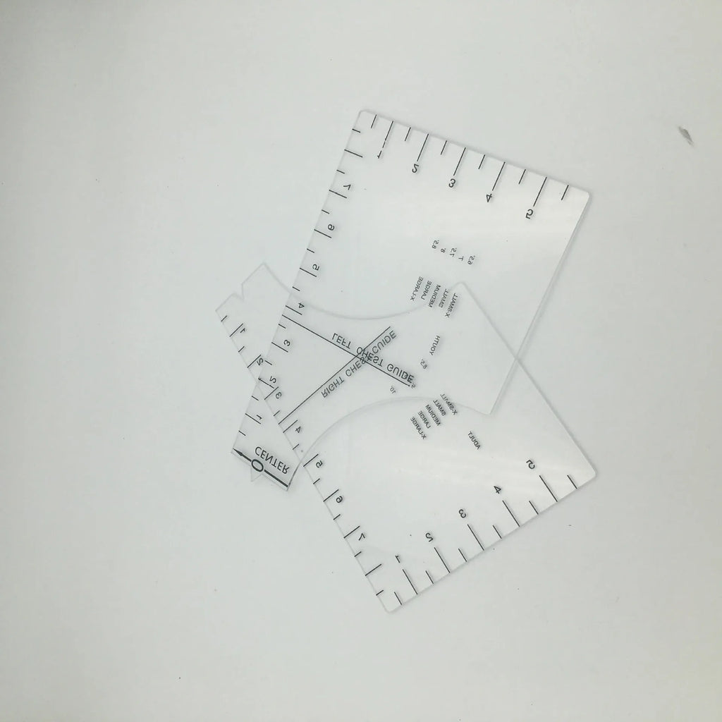 Transparent acrylic sewing ruler for aligning T-shirt designs, measuring 10 by 6 inches.