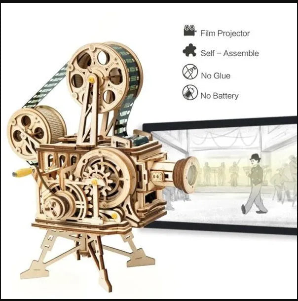 Flat-packed wooden 3D puzzle film projector with visible gear wheel assembly and hand crank