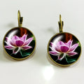 Silver alloy geometric big earring with electroplated gold and sapphire finish on white background