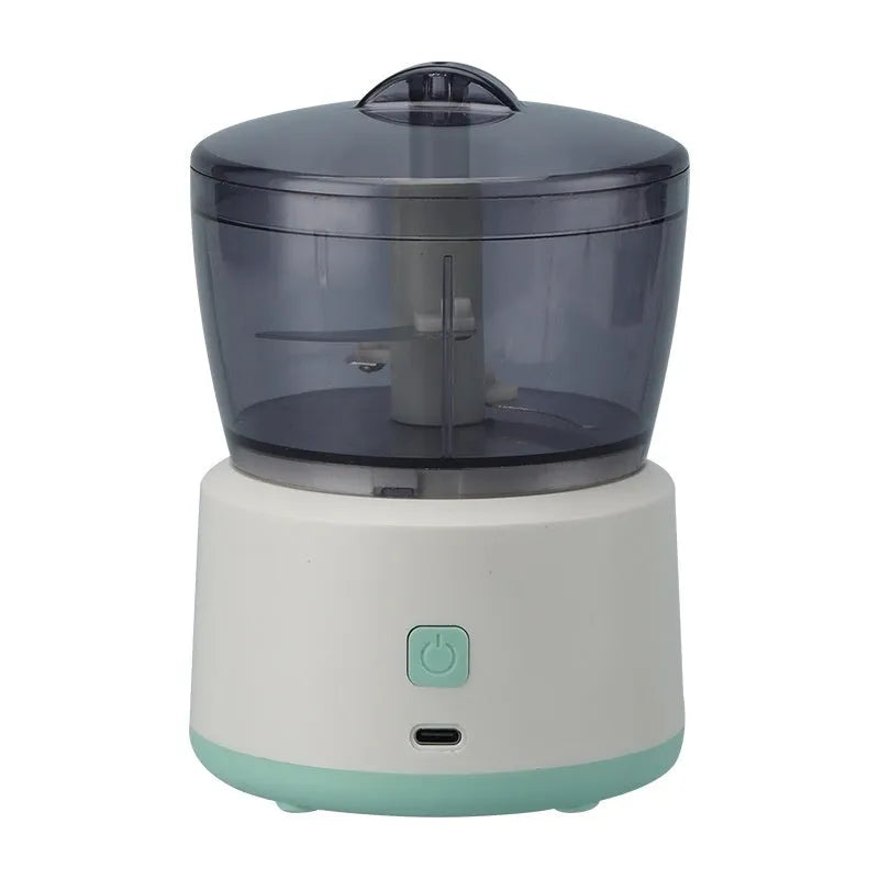 Mini electric meat grinder with transparent cup and stainless steel blades in white or light green