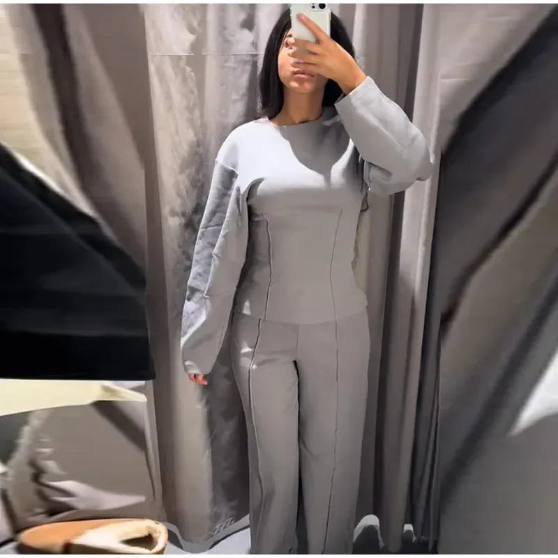 Women's black polar fleece suit with O-neck long sleeve top and wide-leg trousers on a hanger