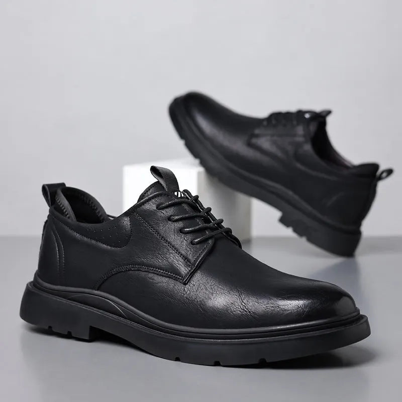 Men's black and brown leather casual sneakers with sewing line detail on the cowhide upper and a rubber sole.