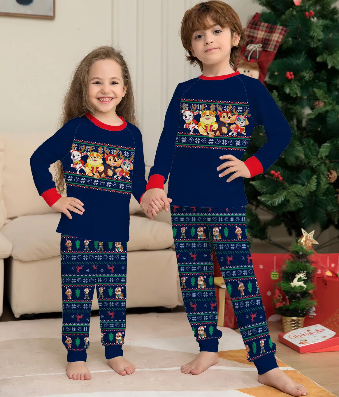 Family wearing matching red plaid Christmas pyjamas with deer print, including adults, children, and a dog.