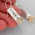 Pair of retro exaggerated rectangle earrings with antique silver finish and snake motif on a plain background