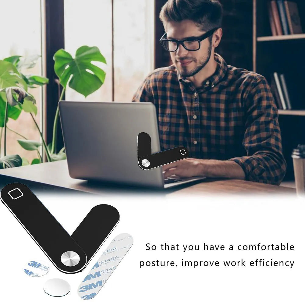 Black aluminium magnetic phone holder attached to side of silver laptop