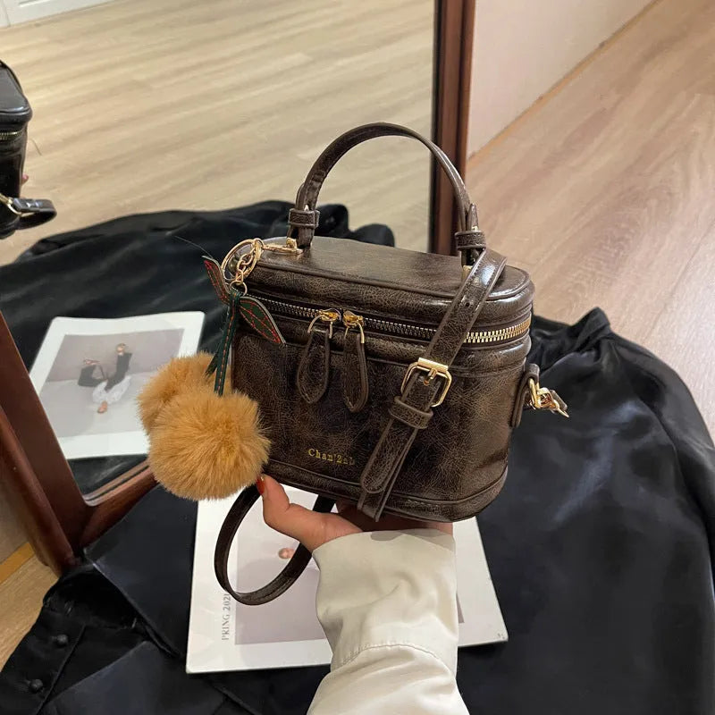 Box bucket bag in PU material with sewing line detail, available in Black, Brown, and Coffee, includes a free pendant
