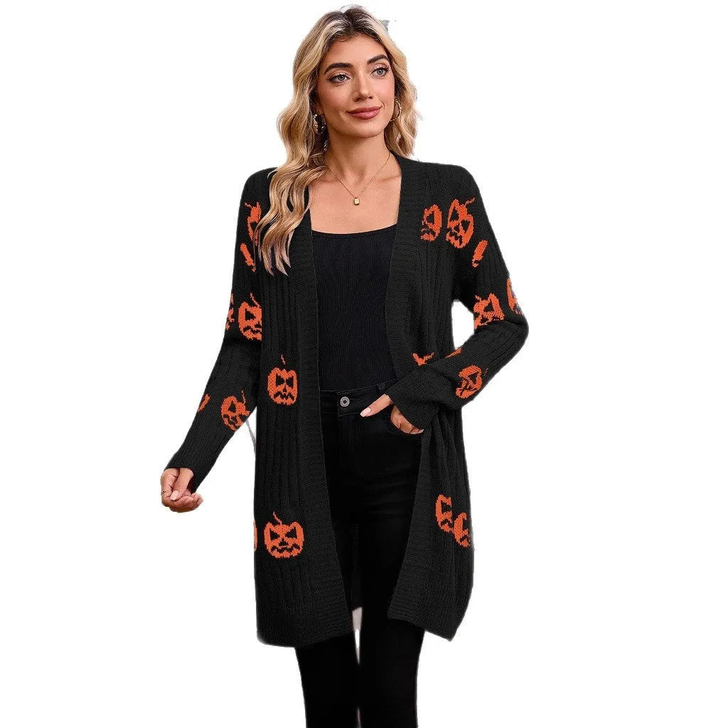 Women's black Halloween cardigan with orange Jacquard knitted pumpkin head pattern, shown on a hanger.