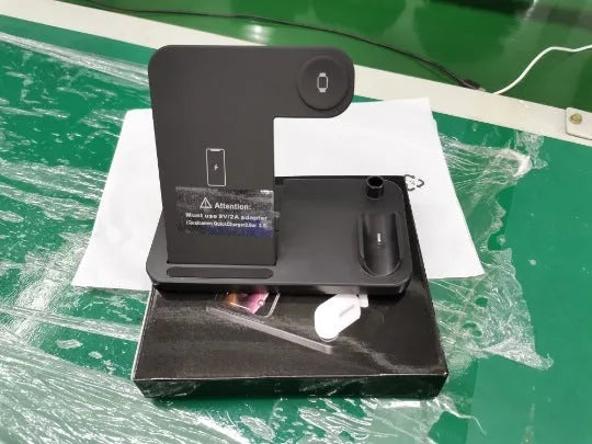 Folding 4-in-1 wireless charging stand in black showing smartphone charging vertically
