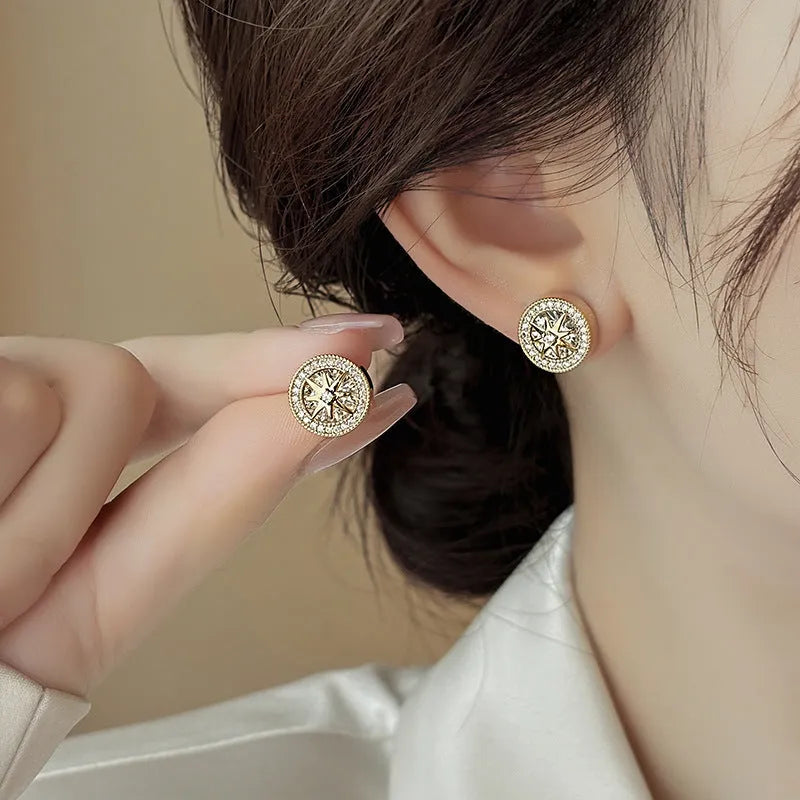 Pair of copper stud earrings with real gold plating and inlaid zircon in an eight-pointed star shape for women