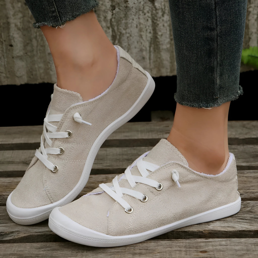 Women's low-top beige fabric casual sneakers on a white background.