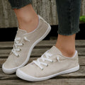 Women's low-top beige fabric casual sneakers on a white background.