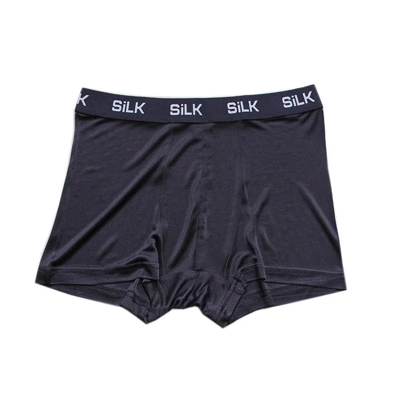 Men's loose navy blue silk shorts with a mid-waist design on a neutral background