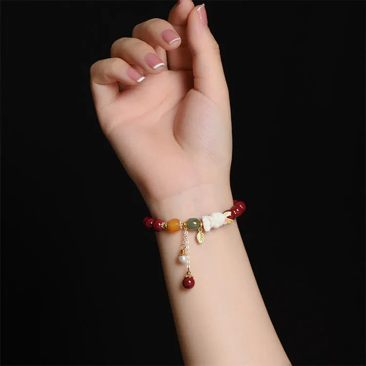 Natural cinnabar rabbit bracelet in national style design showing 8mm and 10mm size options