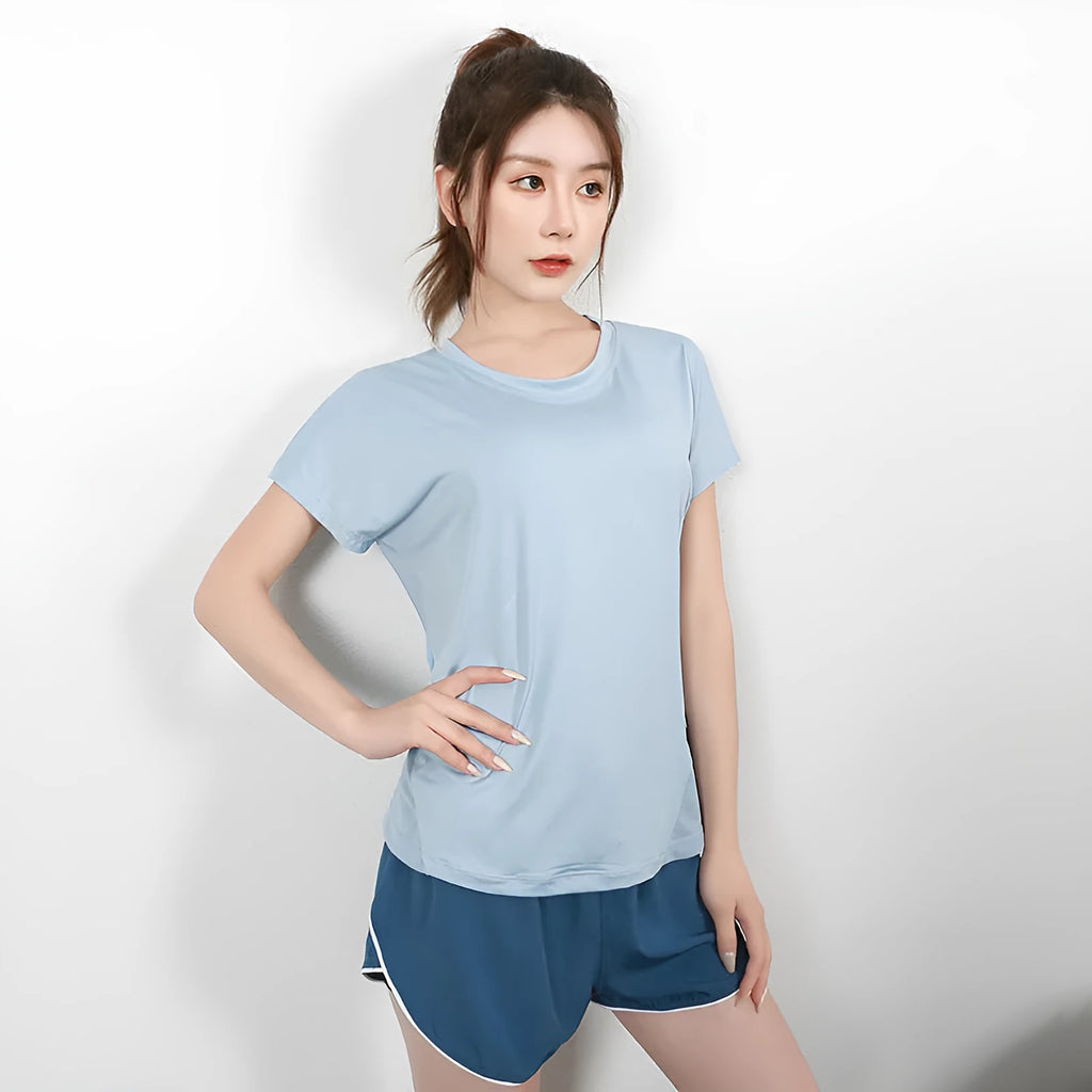 Women's short sleeve polyester sports T-shirt in grey green, shown on a model.