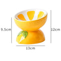 Ceramic raised cat bowl with elevated stand and wide tilted dish in fruit pattern.