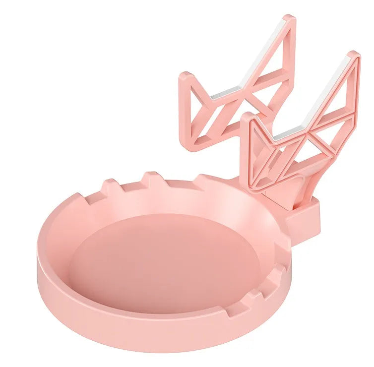 Black ABS plastic X-shaped handle wall hanging rack mounted on a white wall with adhesive glue.