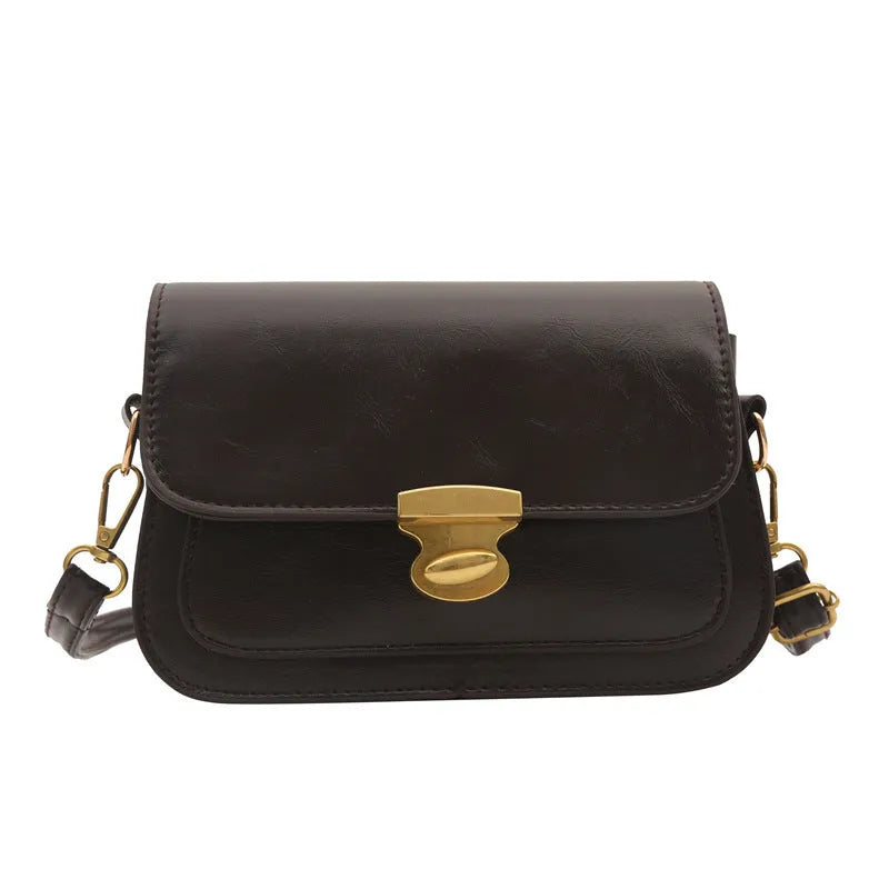 Retro-style square handbag in soft PU leather showing horizontal structure and shoulder strap