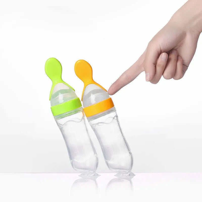 Silicone baby rice paste feeding bottle with suction cup base in blue, green, pink, white, or yellow.