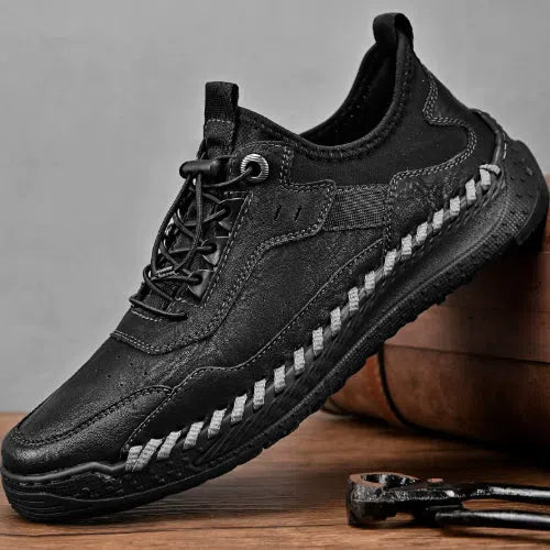 Men's hand-stitched round toe sneakers in black synthetic PU, low heel 1-3 cm, lace-up closure, side view