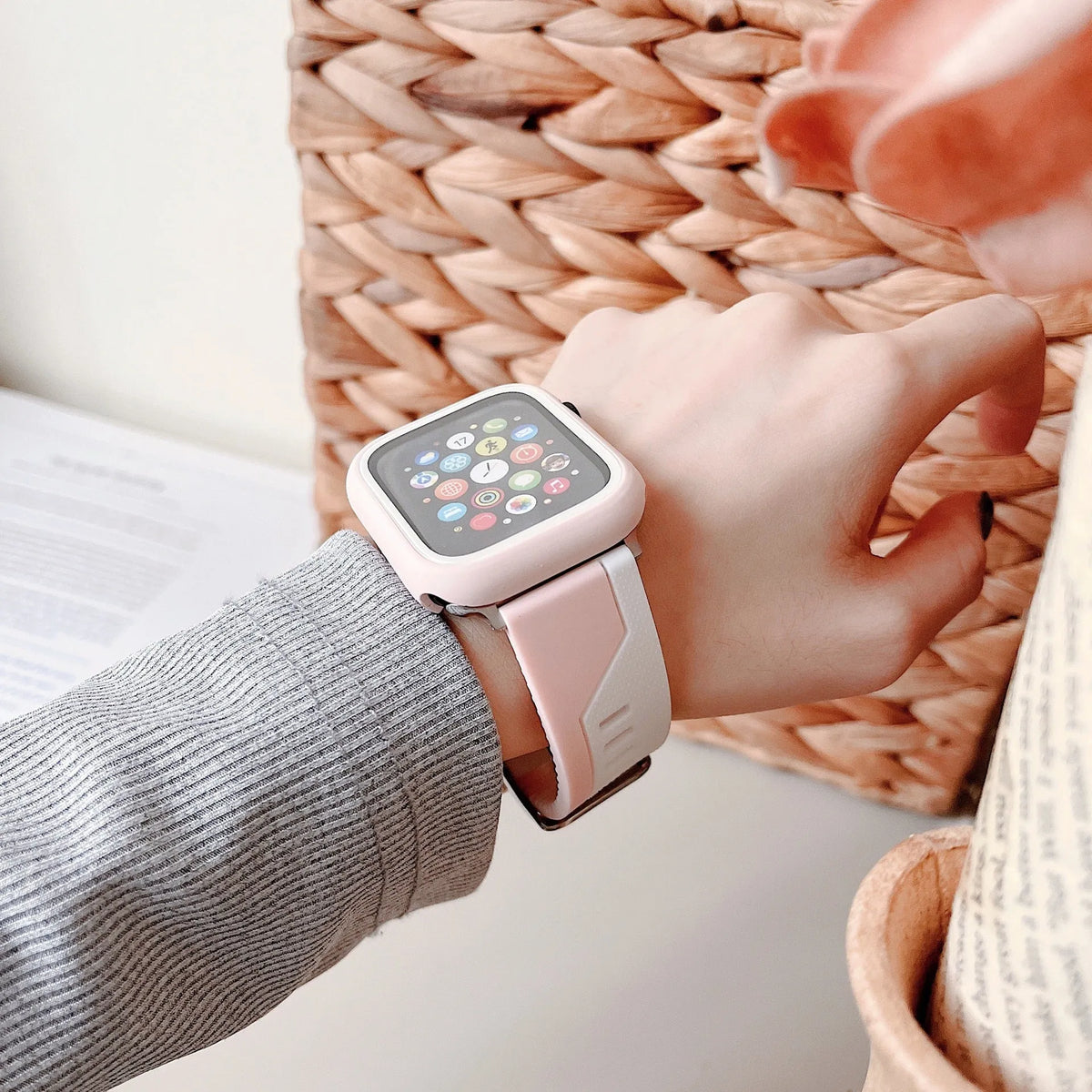 Two-tone silicone protective case for Apple Watch in black and white, fitted on a watch face