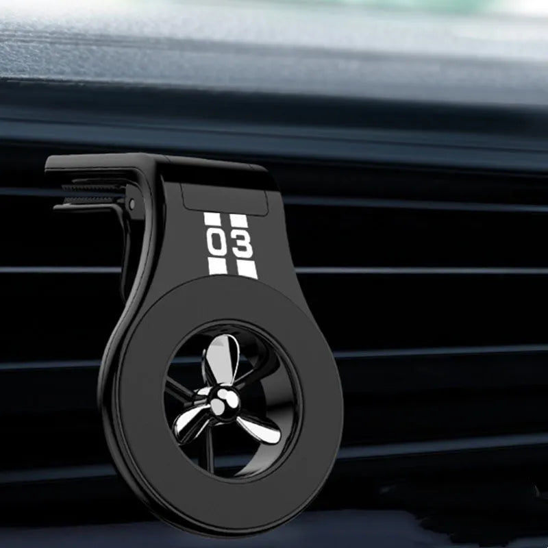 Magnetic car phone holder with fragrance diffuser clipped to car air vent