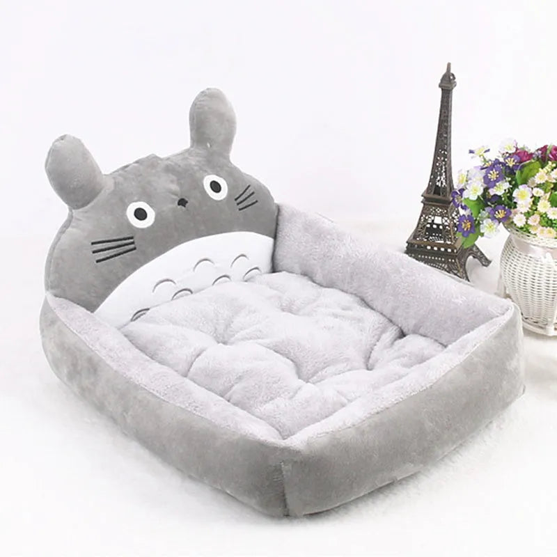 A blue cartoon-style pet sofa bed with raised sides for a small dog, showcasing its washable cover and non-slip base.