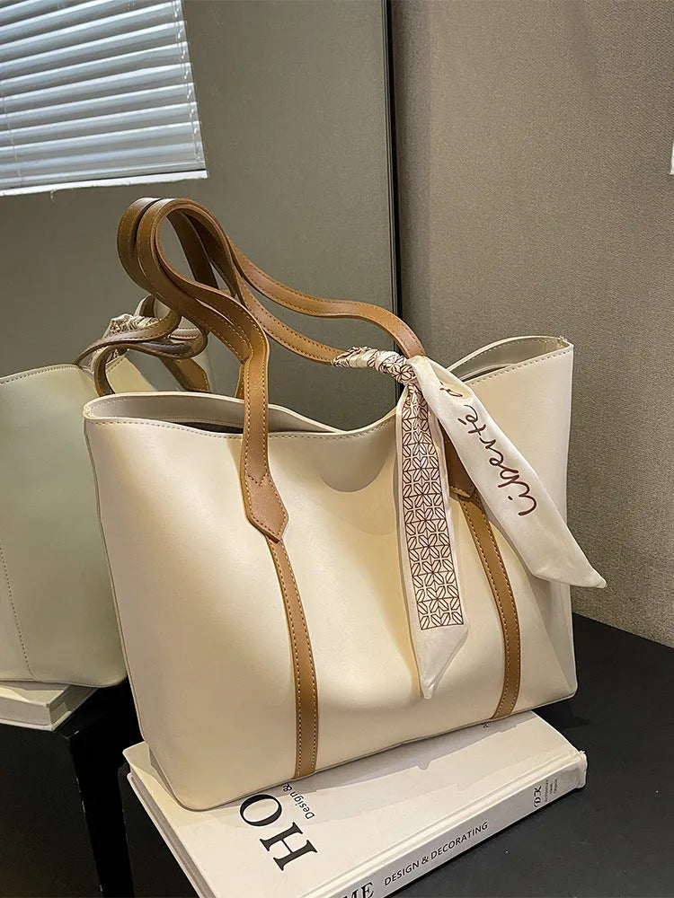 Large capacity tote crossbody bag in bucket style with sandwich pocket design and visible sewing details