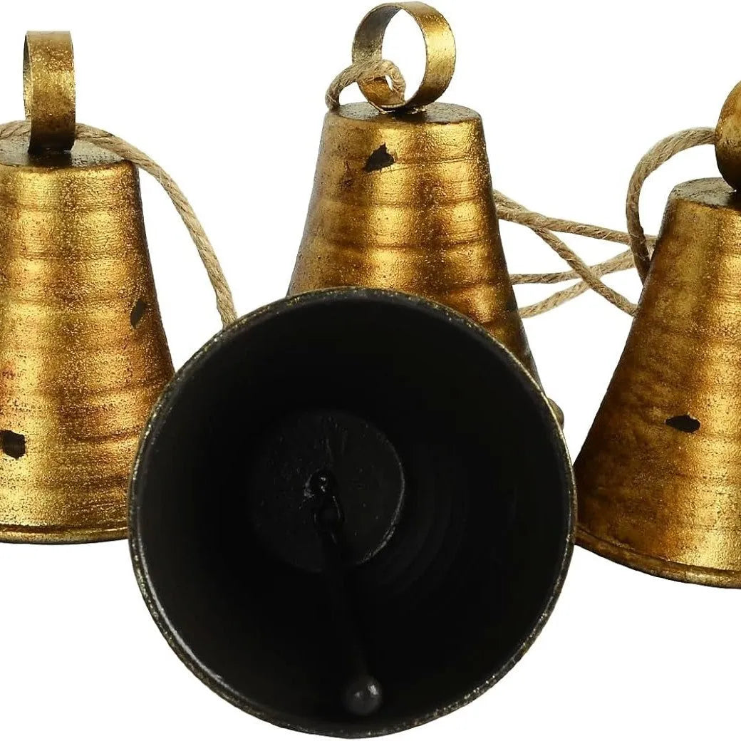 Four retro country handmade metal bells in two colour styles on a rustic wooden background