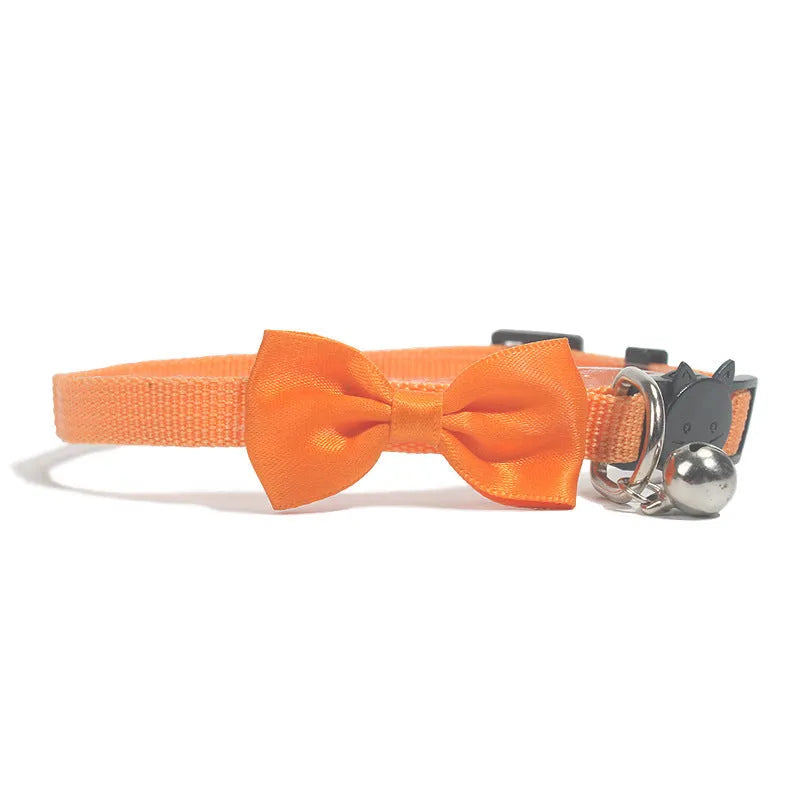 Adjustable nylon cat collar with decorative bow and bell in striped cartoon pattern, multiple colour options shown